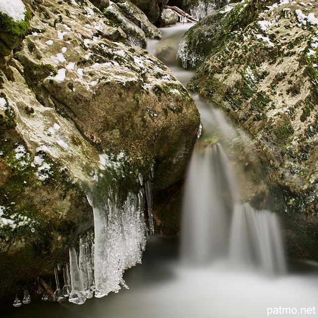 Photographie d'une cascade entoure de stalactites de glace dans le torrent du Fornant en Haute Savoie