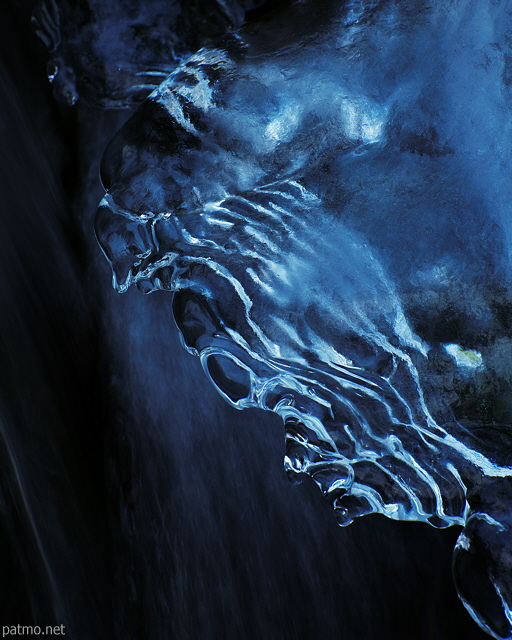 Photo of blue ice and running water in Fornant river