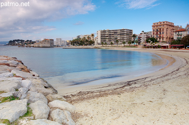 Photo of Toulon in Provence with a sand beach and old buildings