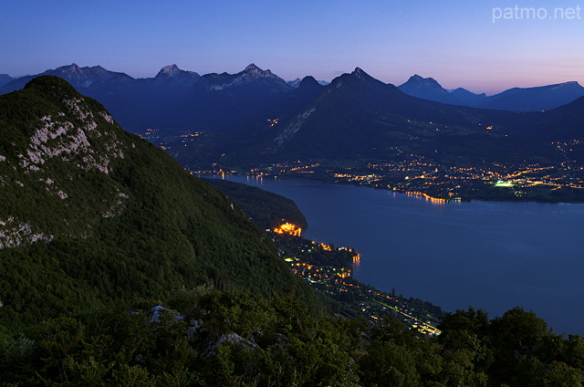 Photographie de la nuit tombante sur le lac d'Annecy et ses montagnes