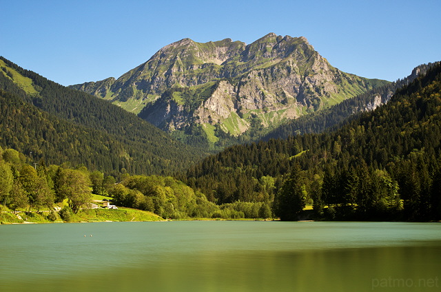Photograph of Roc d'Enfer mountain above the green waters of Vallon lake