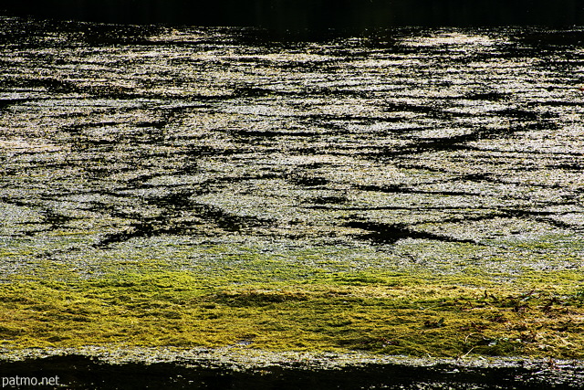 Photo d'éclats lumineux à la surface du lac de Montriond en Haute Savoie