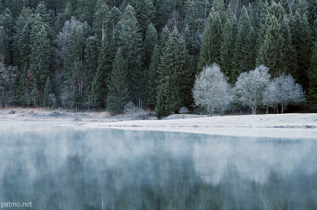 Autumn landscape whitened by frost around lake Genin