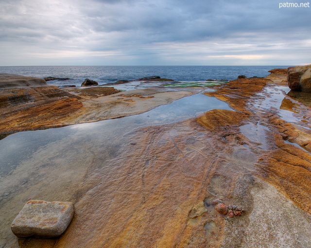 Image of the mediterranean sea under a cloudy sky at Bau Rouge beach in Provence