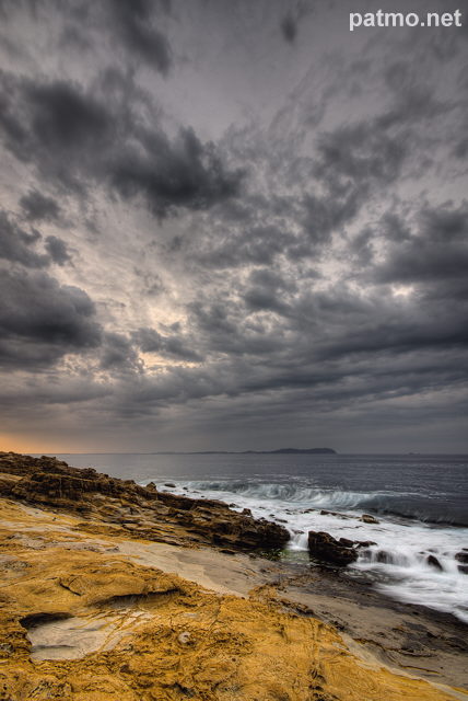 Image of the mediterranean coast under a stormy sky