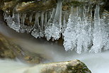 Photo de stalactites de glace suspendues au dessus de l'eau du Fornant en Haute Savoie.