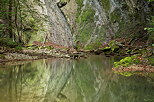 Image of cliff reflection on the water of Fornant river