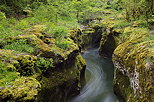 Photo of Seran river at springtime running deep in an limestone crack