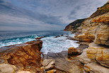 Landscape of the Mediterranean coast with waves and colorful cliffs