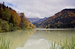 Image of lake Vallon under a cloudy sky and surrounded by the autumn forest