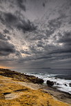 Image of the mediterranean coast under a stormy sky