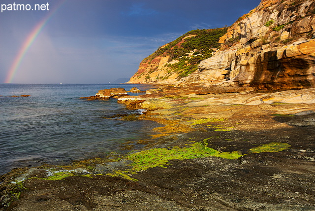 Photo of a rainbow on the Mediterranean sea at Bau Rouge beach in Provence