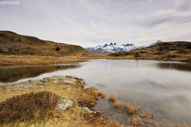 Image of lake Potron and Aiguilles d'Arves mountains in autumn