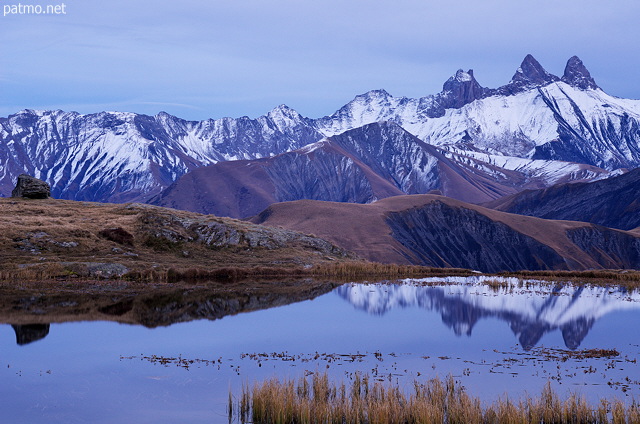 Photo of an autumn dusk in Savoie with a view on lake Guichard and Aiguilles d'Arves mountains