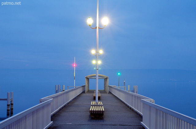 Photograph of city lights at dusk on the deck of Thonon les Bains along Geneva lake