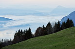 Photograph of Annecy lake under a sea of clouds by an autumn morning