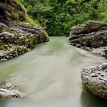 Photo des bords de la rivière du Fornant en Haute Savoie avec des arbres et des rochers