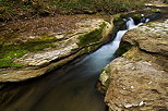 Photograph of a tiny waterfall between the rocks in Petites Usses river bed