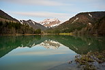 Photograph of a springtime dusk around Vallon lake and Roc d'Enfer mountain in Bellevaux